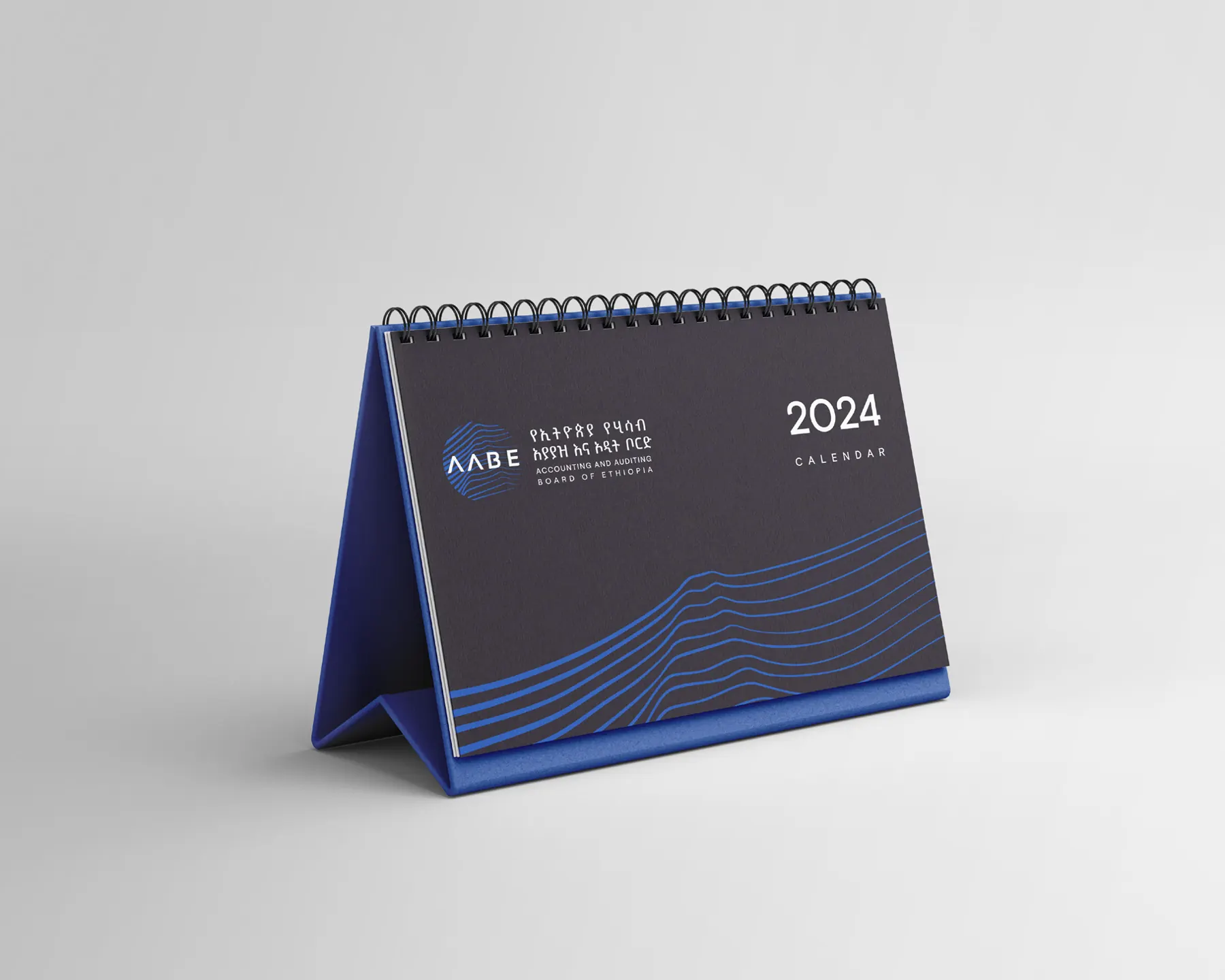 A dark AABE desk calendar for 2024 with blue line pattern.