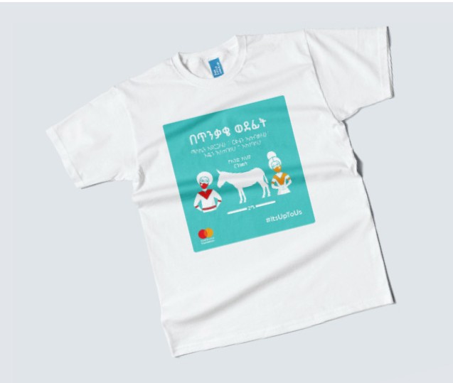 A white campaign T-shirt printed with the artwork: a donkey between two masked figures.