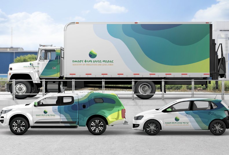 A MiLLS truck, pickup and car wrapped in the flowing brand pattern with the bilingual logo.